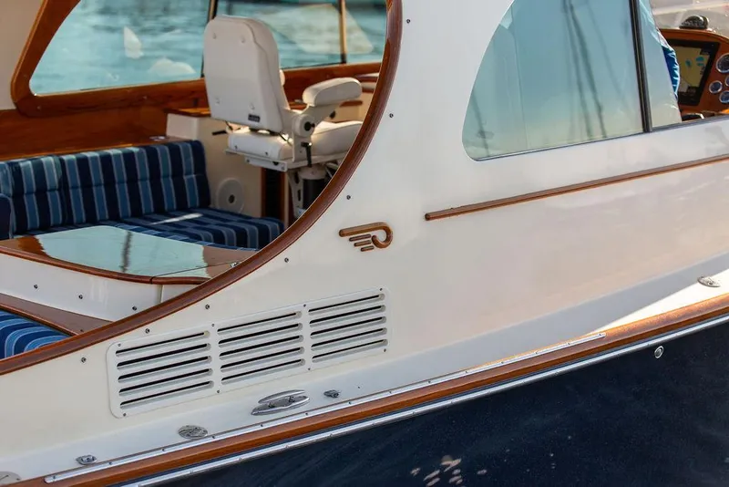Slide: The Image of 2018 Hinckley Picnic Boat 37 MKIII, elegant design with striped seating and wooden accents. - 29