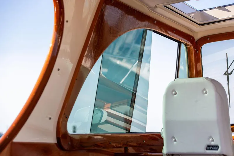 Slide: The Image of Interior view of 2018 Hinckley Picnic Boat 37 MKIII, showcasing window and seating. - 34