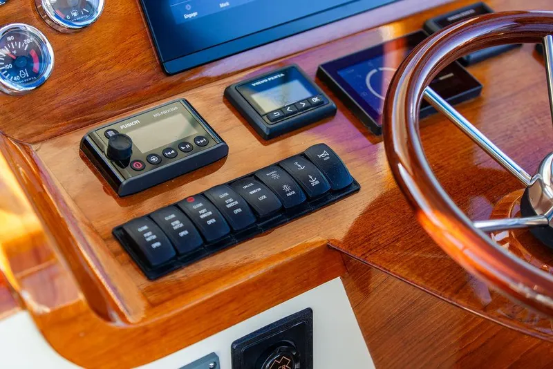 Slide: The Image of Helm controls of 2018 Hinckley Picnic Boat 37 MKIII with wooden finish and modern instruments. - 40