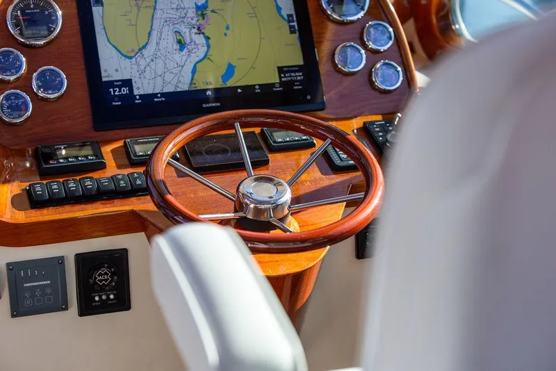 Slide: The Image of Helm of 2018 Hinckley Picnic Boat 37 MKIII with navigation display and wooden steering wheel. - 41
