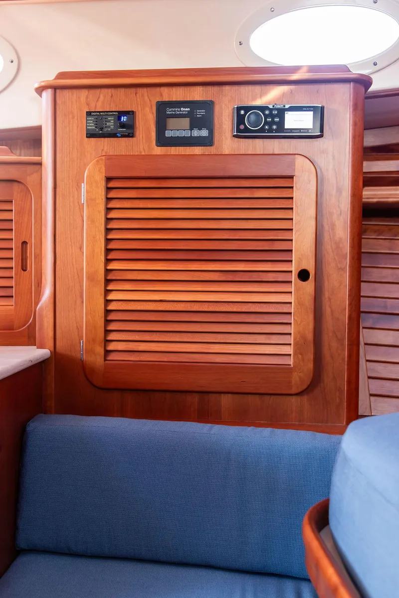 Slide: The Image of 2018 Hinckley Picnic Boat 37 MKIII interior with wooden paneling and blue seating. - 47