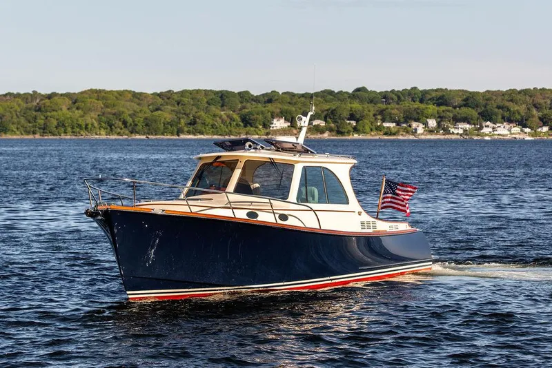 Slide: The Image of 2018 Hinckley Picnic Boat 37 MKIII cruising on open water with American flag. - 6