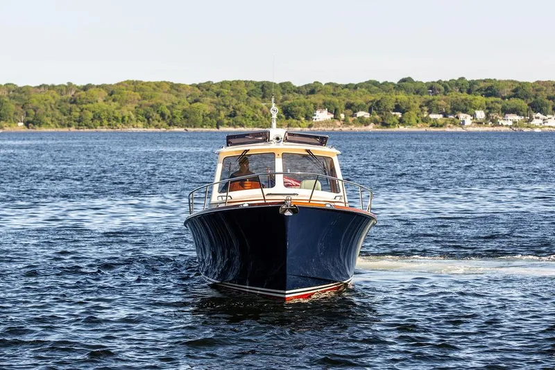 Slide: The Image of 2018 Hinckley Picnic Boat 37 MKIII cruising on a scenic lake. - 7