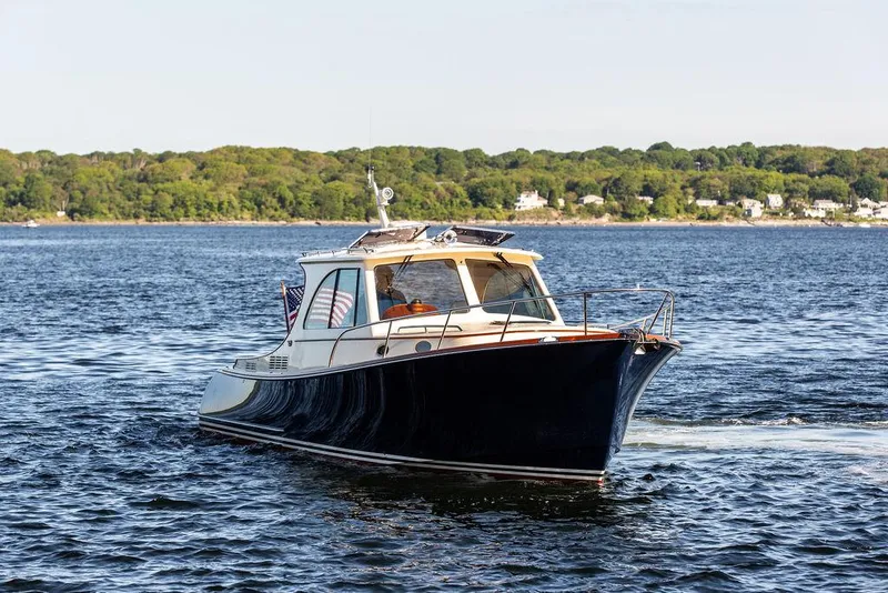 Slide: The Image of 2018 Hinckley Picnic Boat 37 MKIII cruising on a scenic lake. - 8