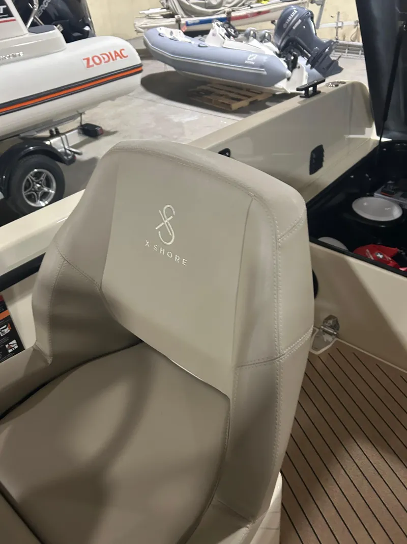 Slide: The Image of 2024 X Shore 1 boat interior with branded seat, showcasing modern design and craftsmanship. - 11