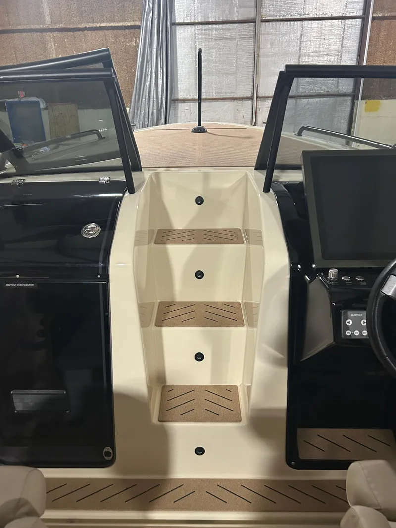 Slide: The Image of 2024 X Shore 1 boat interior with steps and control panel. - 12