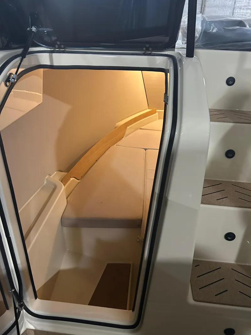 Slide: The Image of 2024 X Shore 1 boat interior cabin with steps, showcasing modern design and lighting. - 15