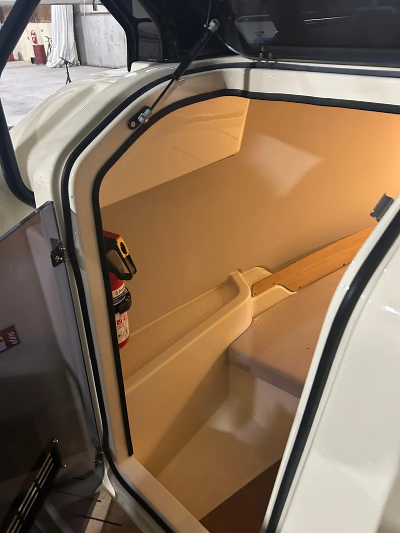 Slide: The Image of 2024 X Shore 1 interior cabin with fire extinguisher, showcasing modern design and safety features. - 16