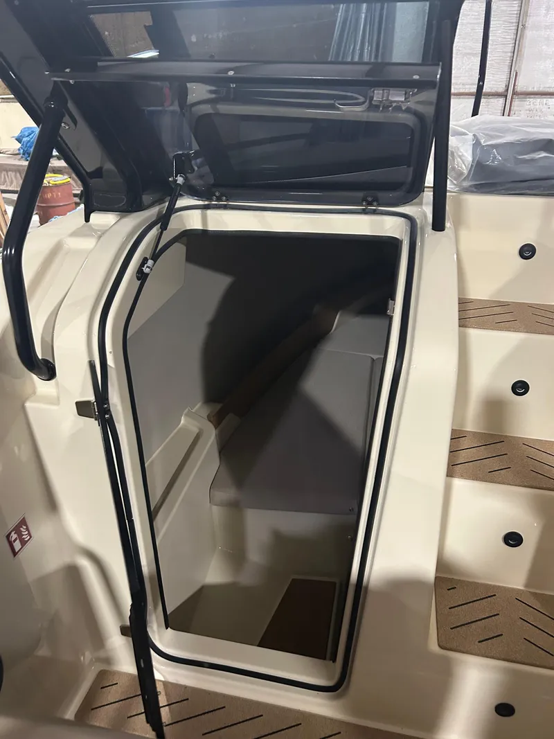 Slide: The Image of 2024 X Shore 1 boat interior cabin entrance with open hatch and steps. - 17