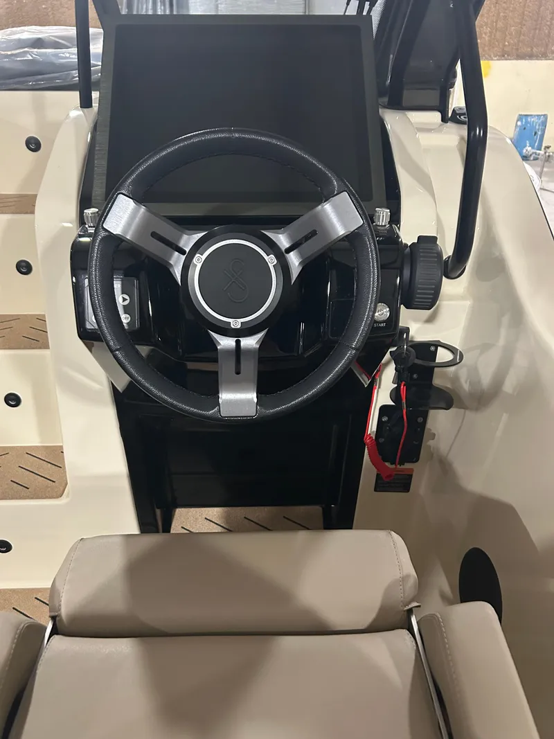 Slide: The Image of 2024 X Shore 1 boat steering wheel and dashboard interior view. - 9
