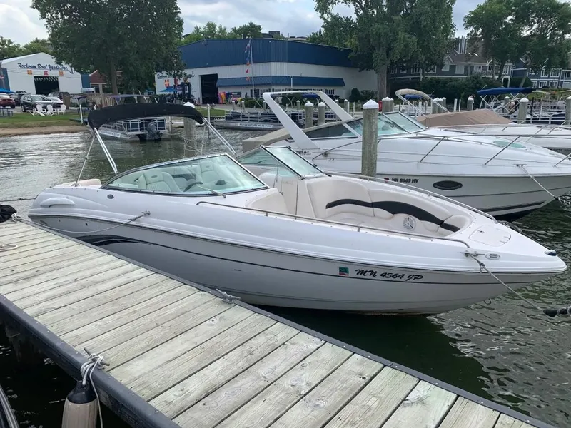 The Image of Chaparral 260 SSi 2003 boat docked at a marina, surrounded by other boats. - 0