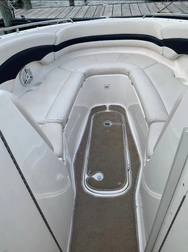 Slide: The Image of 2003 Chaparral 260 SSi boat interior with white seating and carpeted floor. - 3