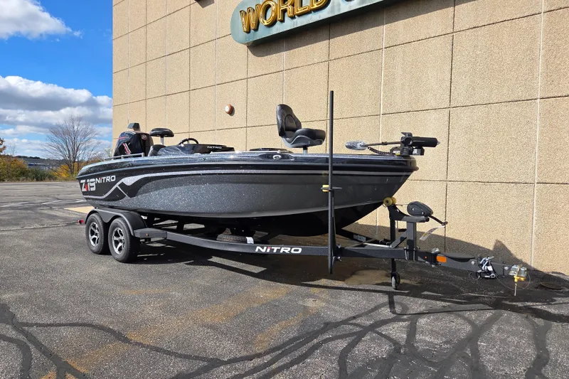The Image of 2025 Nitro ZV19 boat on trailer, parked outdoors near a building. - 0