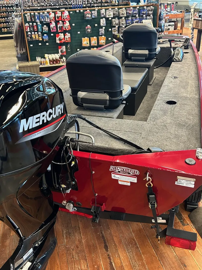 Slide: The Image of 2025 Tracker Panfish 17 boat with Mercury engine, displayed indoors on wooden floor. - 39