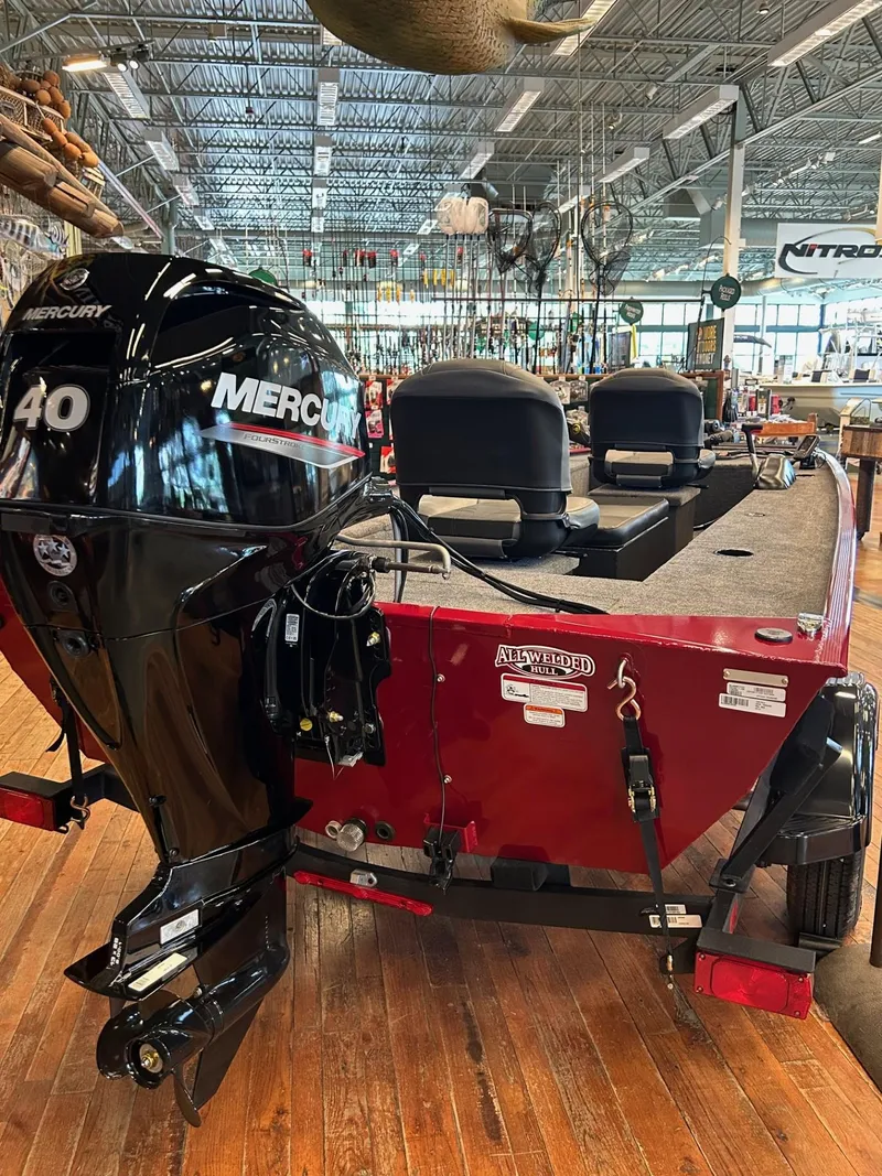Slide: The Image of 2025 Tracker Panfish 17 boat with Mercury engine displayed indoors. - 40