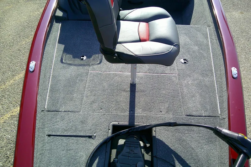 Slide: The Image of 2025 Tracker Pro Team 175 boat interior with gray carpet and swivel seat. - 10