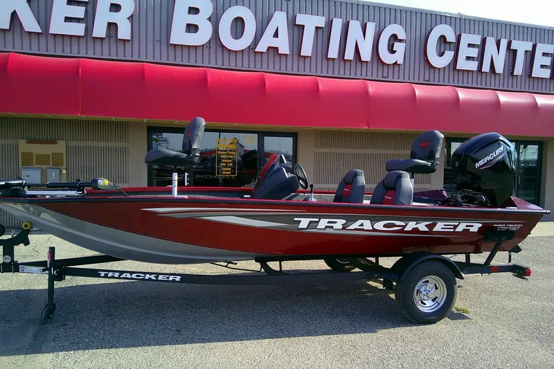 Slide: The Image of 2025 Tracker Pro Team 175 boat displayed at a boating center. - 2