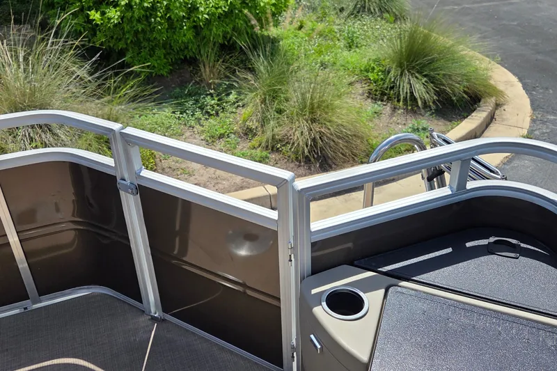 Slide: The Image of 2025 Sun Tracker SportFish 20 DLX pontoon boat deck with railing and cup holder. - 18