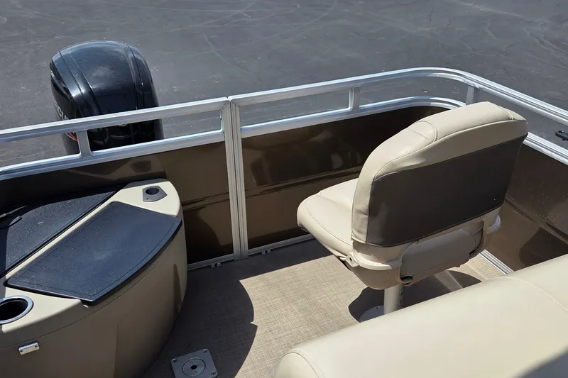 Slide: The Image of 2025 Sun Tracker SportFish 20 DLX boat interior with seating and motor view. - 15