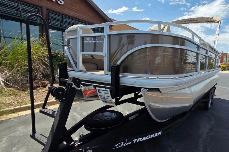 Slide: The Image of 2025 Sun Tracker SportFish 20 DLX pontoon boat on trailer, outdoor display. - 13