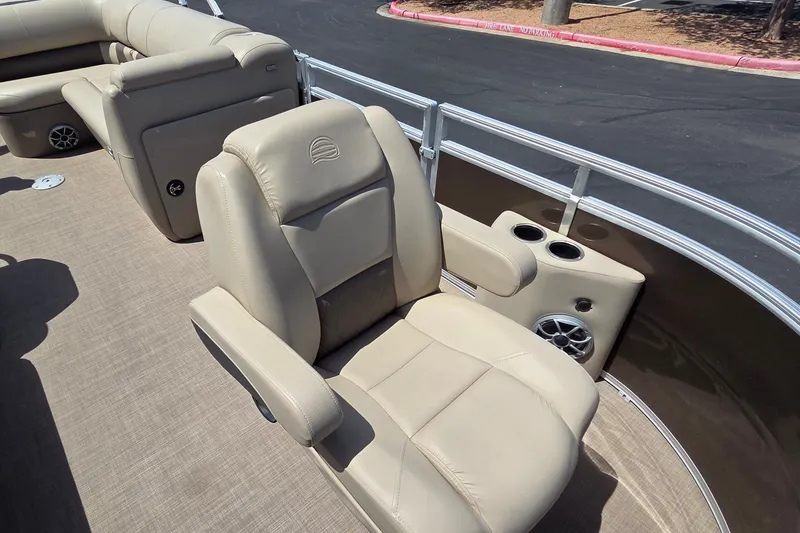 Slide: The Image of Luxurious seating on 2025 Sun Tracker SportFish 20 DLX pontoon boat, featuring cup holders and speaker. - 17
