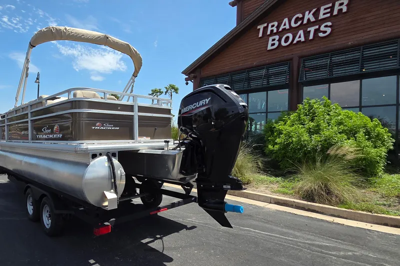 Slide: The Image of 2025 Sun Tracker SportFish 20 DLX pontoon boat outside Tracker Boats dealership. - 16