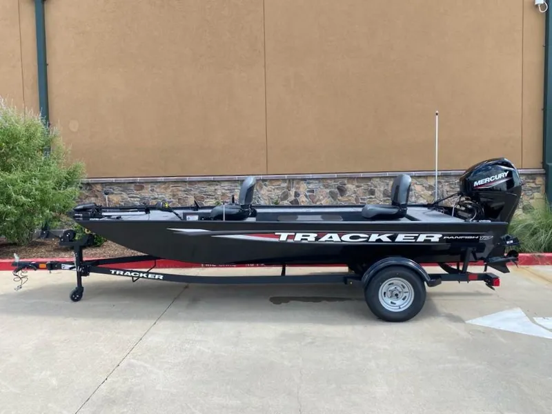 The Image of 2025 Tracker Panfish 17 boat with Mercury engine on trailer, parked outdoors. - 0