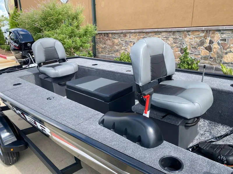 Slide: The Image of 2025 Tracker Panfish 17 boat interior with two gray seats and a Mercury outboard motor. - 6