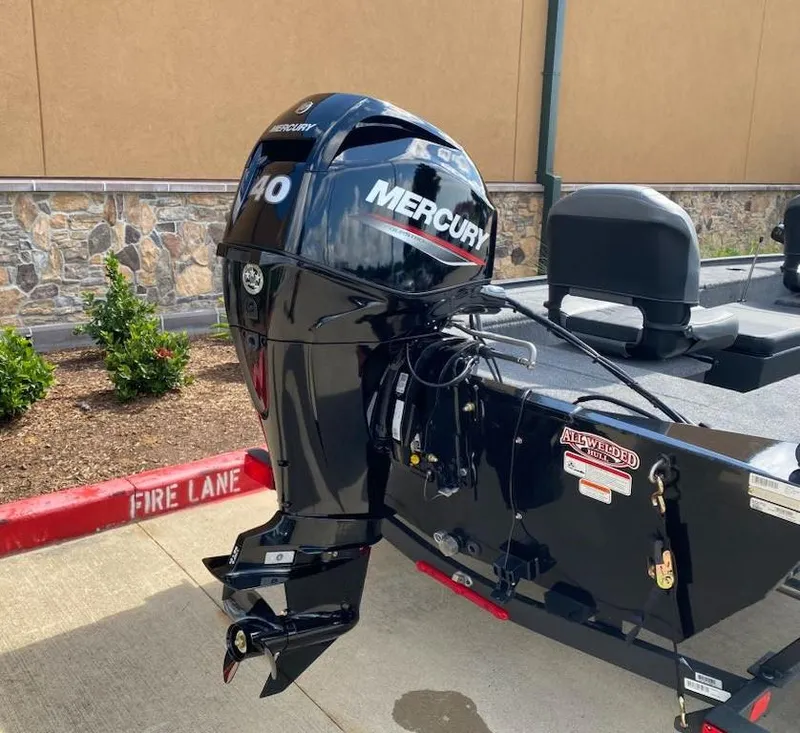Slide: The Image of 2025 Tracker Panfish 17 boat with Mercury outboard motor in a parking area. - 8