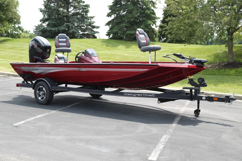 The Image of 2025 Ranger RT188 boat in red, parked on a trailer in a scenic outdoor setting. - 0