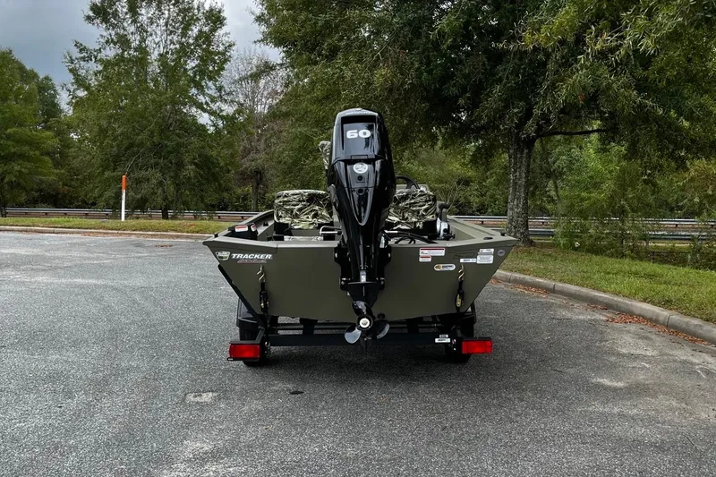Slide: The Image of 2025 Tracker Grizzly 1754 SC boat on trailer, parked outdoors, rear view. - 15