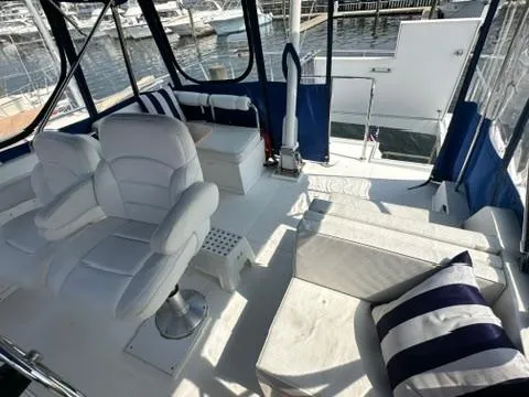 Slide: The Image of 2009 Marine Trader 36 Euro Sedan interior with white seating and striped cushions. - 14