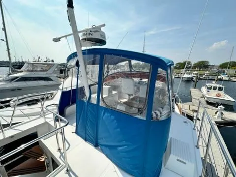 Slide: The Image of 2009 Marine Trader 36 Euro Sedan yacht with blue canopy docked at marina. - 15
