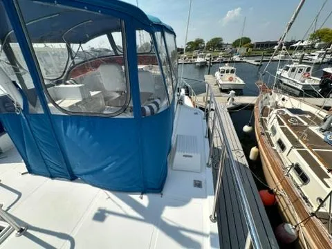 Slide: The Image of 2009 Marine Trader 36 Euro Sedan docked at a marina, featuring a blue canopy. - 16