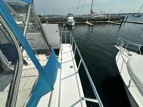 Slide: The Image of 2009 Marine Trader 36 Euro Sedan docked at marina, view of deck and surrounding boats. - 18