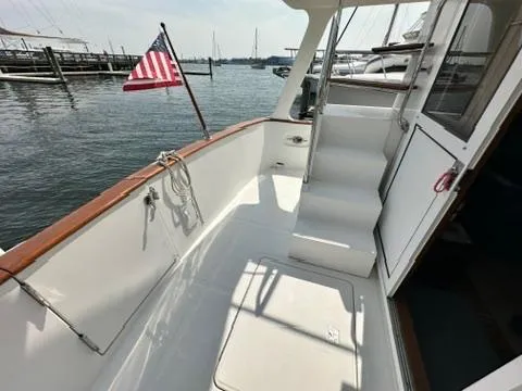 Slide: The Image of 2009 Marine Trader 36 Euro Sedan boat deck with American flag, docked at marina. - 20