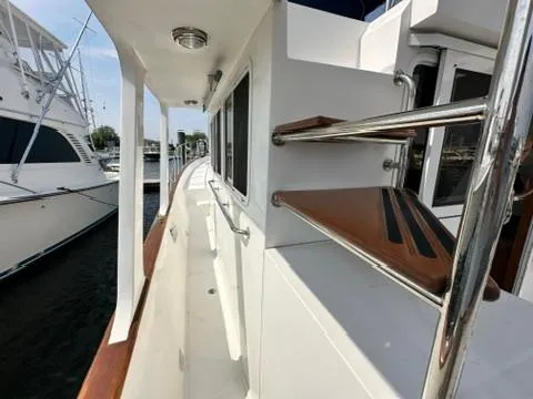 Slide: The Image of 2009 Marine Trader 36 Euro Sedan yacht, side view with wooden railings and steps. - 21