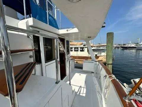Slide: The Image of 2009 Marine Trader 36 Euro Sedan yacht docked at marina, featuring spacious deck and elegant design. - 22