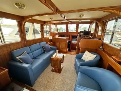 Slide: The Image of Interior of 2009 Marine Trader 36 Euro Sedan with blue seating and wooden accents. - 29