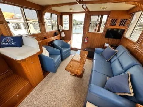 Slide: The Image of Interior of 2009 Marine Trader 36 Euro Sedan with blue seating and wooden accents. - 30