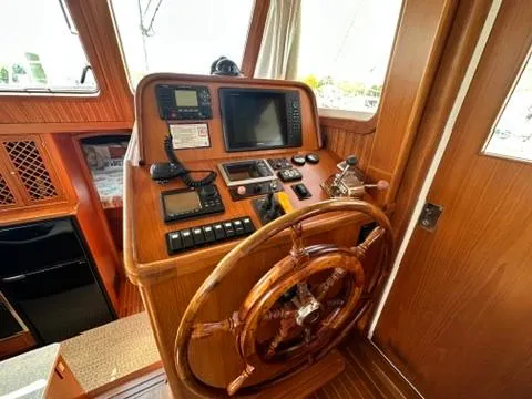 Slide: The Image of 2009 Marine Trader 36 Euro Sedan helm with wooden wheel and navigation instruments. - 32