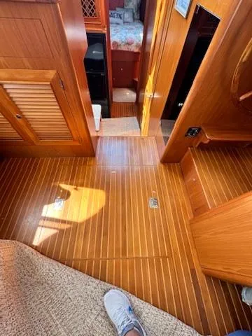Slide: The Image of Interior of 2009 Marine Trader 36 Euro Sedan with wooden flooring and cozy cabin space. - 36