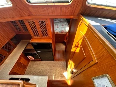 Slide: The Image of Interior of 2009 Marine Trader 36 Euro Sedan with wood finish and compact kitchen. - 37