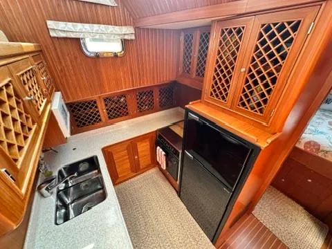 Slide: The Image of 2009 Marine Trader 36 Euro Sedan galley with wood cabinetry and modern appliances. - 38