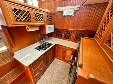 Slide: The Image of Luxurious 2009 Marine Trader 36 Euro Sedan yacht kitchen with wood cabinetry and modern appliances. - 40