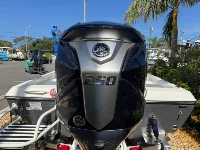 Slide: The Image of 2025 Skeeter SX 230 boat with Yamaha 250 outboard motor, parked outdoors. - 10