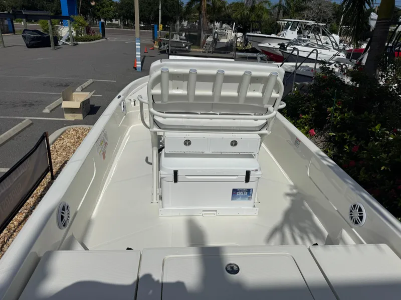 Slide: The Image of 2025 Skeeter SX 230 boat interior with seating and storage, parked in a marina. - 13