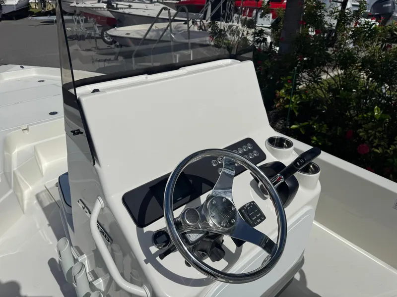 Slide: The Image of 2025 Skeeter SX 230 boat console with steering wheel and controls. - 17
