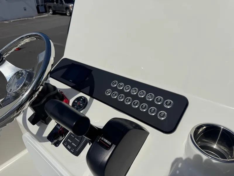 Slide: The Image of 2025 Skeeter SX 230 boat dashboard with steering wheel and control panel. - 19