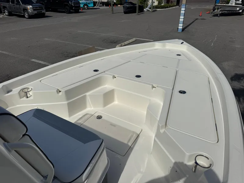 Slide: The Image of 2025 Skeeter SX 230 boat deck in a parking lot, showcasing spacious seating and storage. - 20